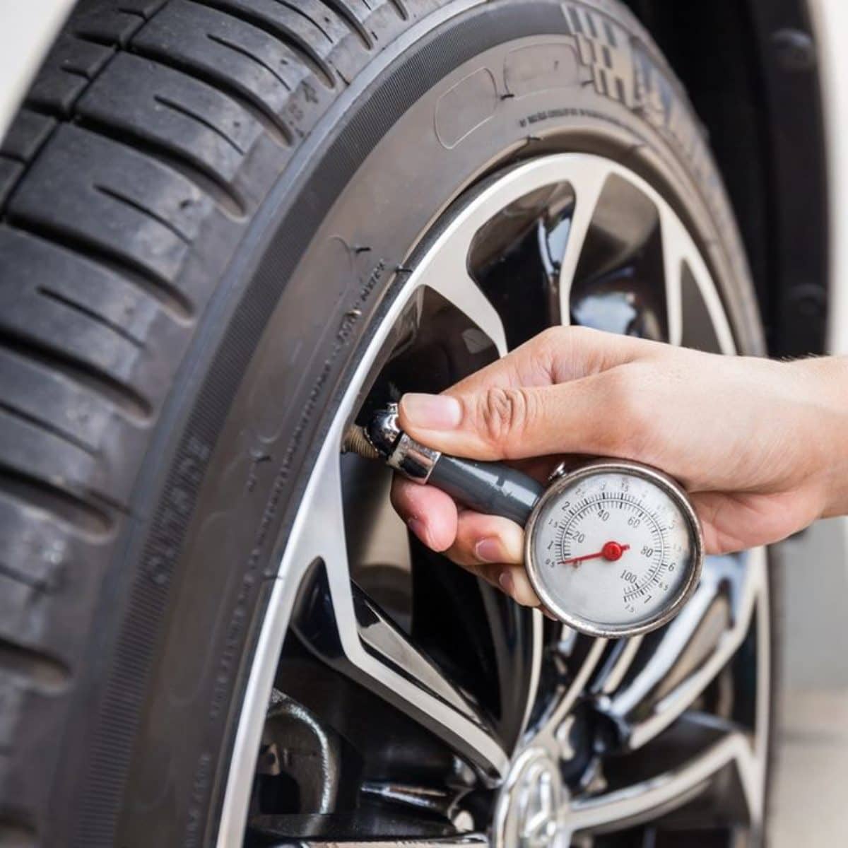 Mechanic Fixing Tire Pressure